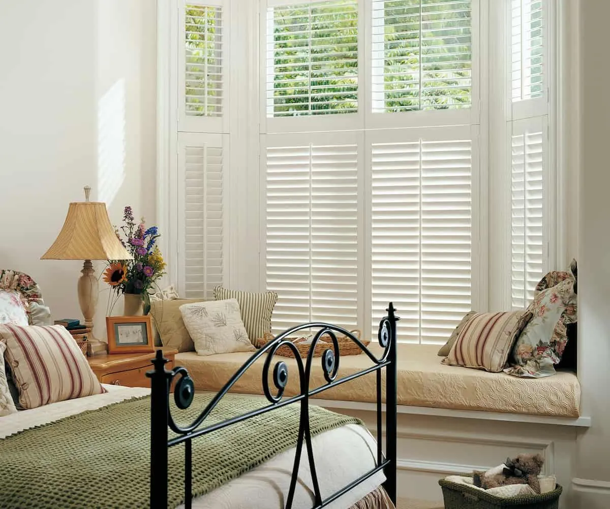 Cosy bedroom with white plantation shutters