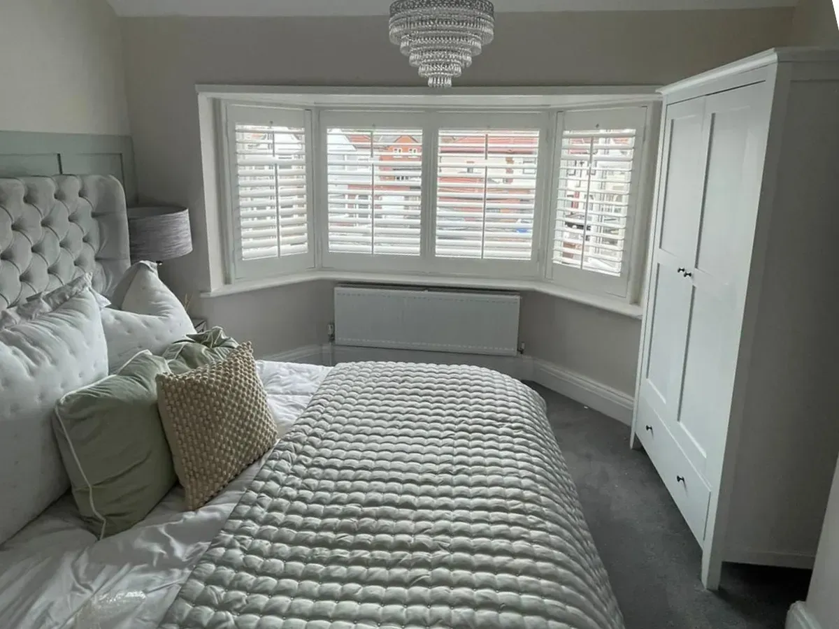 York bedroom with bay window shutters